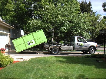 Truck Delivering Dumpster